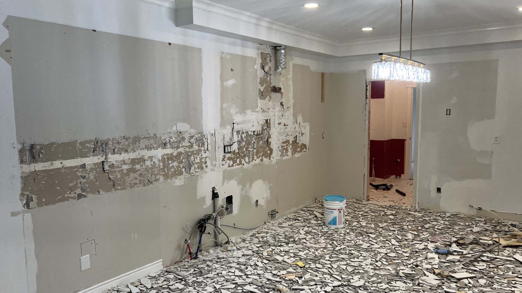 The Capilano kitchen stripped back during demolition, with the dividing wall removed and the original wall substrate exposed